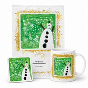 A personalized Christmas-themed mug, coaster and T-Towel bundle. The white ceramic mug, square coaster and t-towel feature a green background with a white snowman, white snowflakes.