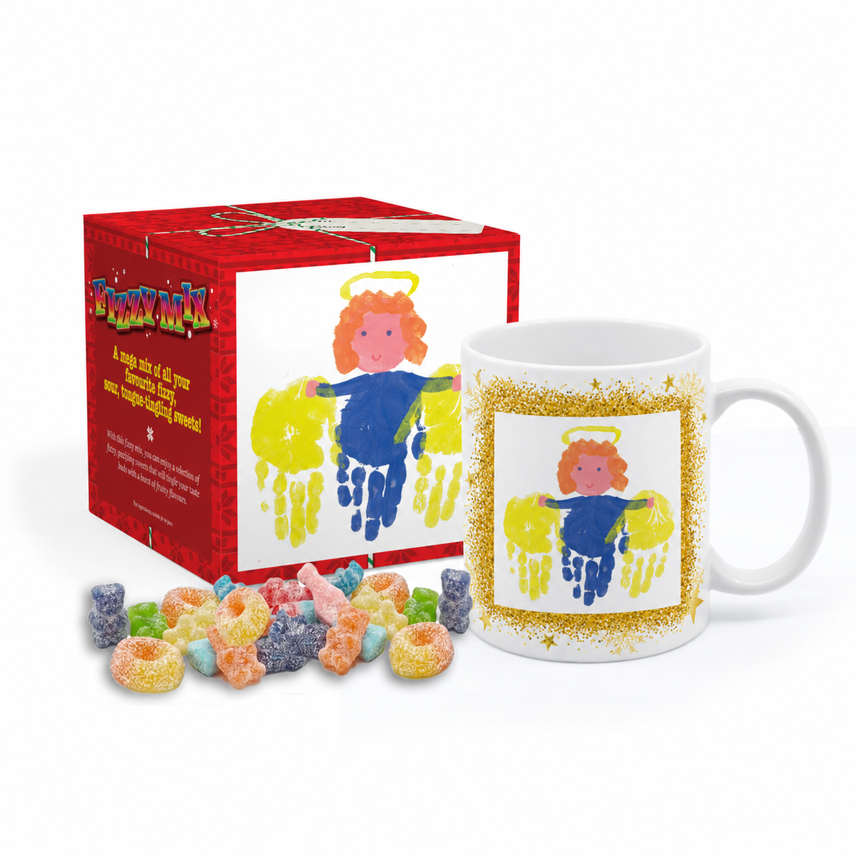 A white ceramic mug with a colorful angel handprint design, shown next to its red gift box and a small pile of assorted fizzy sweets on a white background.